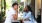a man and woman sitting at a table outside