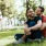 a man and woman sitting on grass