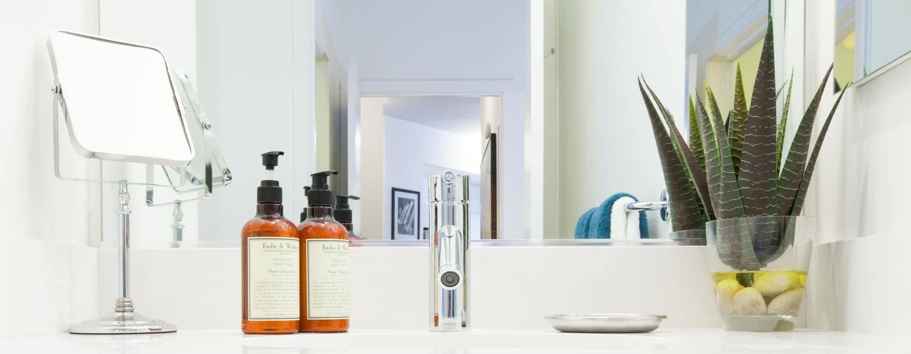 a bathroom counter with a sink and a mirror